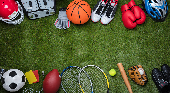 High Angle View Of Various Sport Equipments On Green Grass